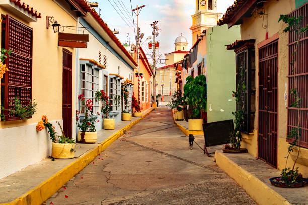 pov photo of a colonial street in landscape format, with a church at the end